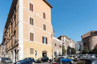 a group of cars parked on a street next to a building at Accogliente Appartamento al Colosseo in Rome