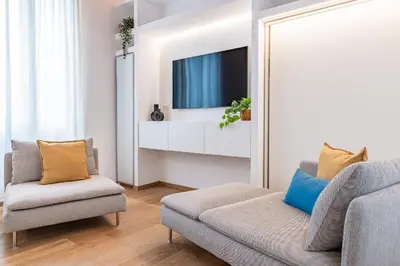 a living room with a couch and a tv at Casa Scalzi in Rome