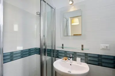 a bathroom with a sink and a shower at Midnight in Rome Guest House in Rome