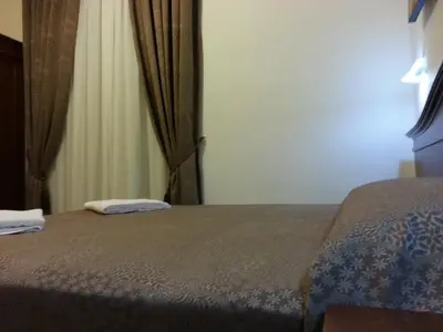 a bedroom with a bed and a window at Guesthouse Alex II in Rome