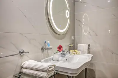 a hotel room with a bed and a chair at Piazza di Spagna Just for Us in Rome