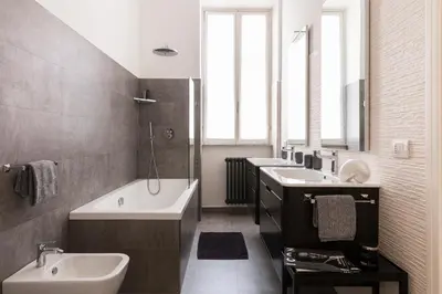 a bathroom with two sinks and a bath tub and a bath tub at Maison Letizia Roma in Rome