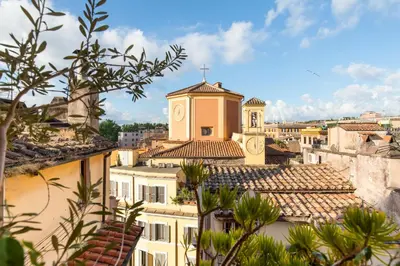 a view of the roofs of a city with a church at Piazza Mattei Terrace Apartment | Romeloft in Rome