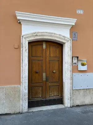 a large wooden door in the side of a building at Santa Bibiana B&B in Rome