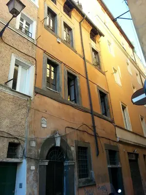 an old building with many windows on a street at The Piccolo Apartment in Rome