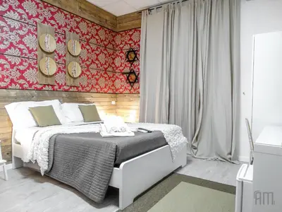 a bedroom with a bed and a red wall at Magic Door Rome in Rome