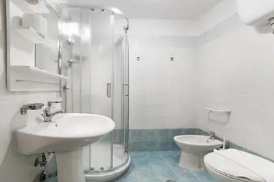 a bathroom with a sink and a toilet and a shower at Magic Door Rome in Rome