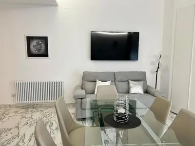 a living room with a couch and a glass table at Casa Malupa Luxury Apartments in Rome