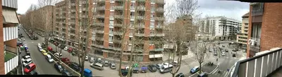 a city street with cars parked in front of a building at Casa Malupa Luxury Apartments in Rome