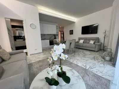 a living room with a table with white flowers on it at Casa Malupa Luxury Apartments in Rome