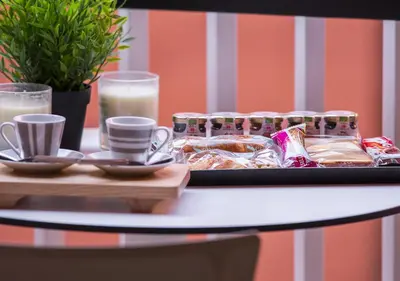 a tray of food on a table with glasses of milk at Casa Malupa Luxury Apartments in Rome