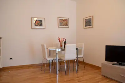 a dining room with a table and chairs and a television at Roma Caput Mundi in Rome
