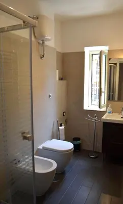 a bathroom with a toilet and a glass shower at Roma Caput Mundi in Rome