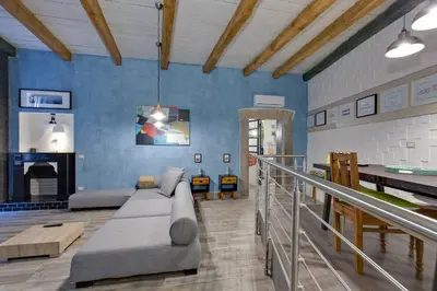 a living room with a couch and a fireplace at Rome As You Feel - Design Apartment at Colosseum in Rome