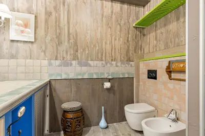 a bathroom with a toilet and a sink at Rome As You Feel - Design Apartment at Colosseum in Rome