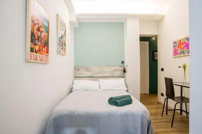 a bedroom with a bed with a green towel on it at Le Stanze Di Paola in Rome