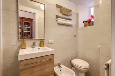 a bathroom with a sink and a toilet and a mirror at Vaticano casa tua in Rome