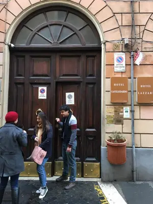 a group of people standing in front of a door at Zidan Guest House in Rome