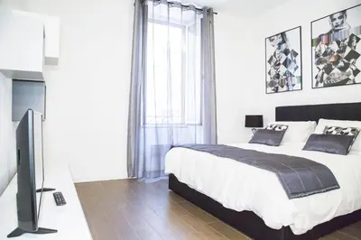 a bedroom with a bed and a flat screen tv at Argentina Exclusive Apartment in Rome