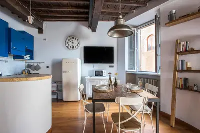 a kitchen and dining room with a table and chairs at AndreaSuite - Piazza Navona in Rome