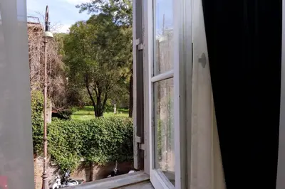 an open window with a view of a garden at Dolce Casa Colosseo in Rome