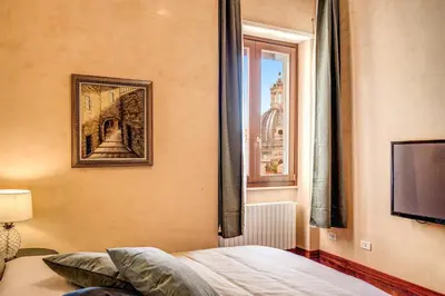 a bedroom with a bed and a window at DOWNTOWN SRL - Imperial Panorama Penthouse in Rome