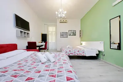 a large room with two beds and a table at Lucky Holiday Rooms in Rome