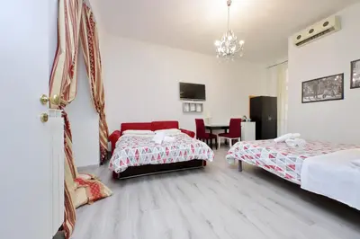 a hotel room with two beds and a table at Lucky Holiday Rooms in Rome
