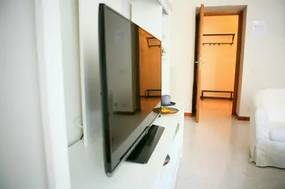 a living room with a large flat screen tv on a wall at Linda Musei Vaticani in Rome