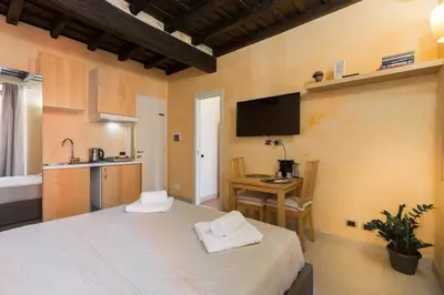 a room with a bed and a table with towels at TrinitaDeiMonti Guest House in Rome