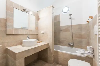 a bathroom with a sink and a toilet and a shower at TrinitaDeiMonti Guest House in Rome