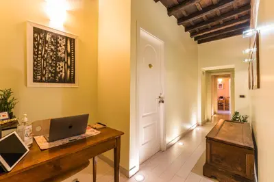 a home office with a laptop on a wooden desk at TrinitaDeiMonti Guest House in Rome