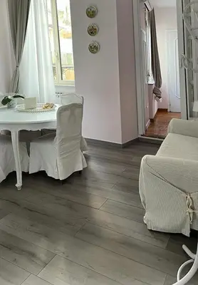 a living room with a table and a chair at ROMA - Loft Campo de' Fiori - Appartamento Campo de' Fiori - LE CUGINE in Rome