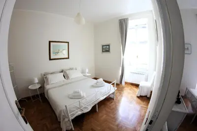 a bedroom with a white bed and a mirror at ROMA - Loft Campo de' Fiori - Appartamento Campo de' Fiori - LE CUGINE in Rome