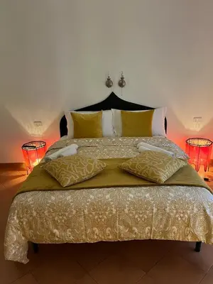 a bedroom with a large bed with two lamps at CK Rooms in Rome