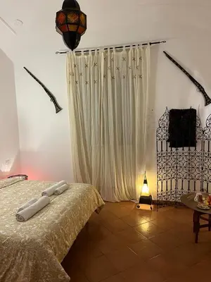 a bedroom with a bed and a white curtain at CK Rooms in Rome