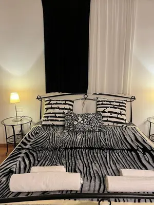 a large bed with black and white pillows on it at CK Rooms in Rome