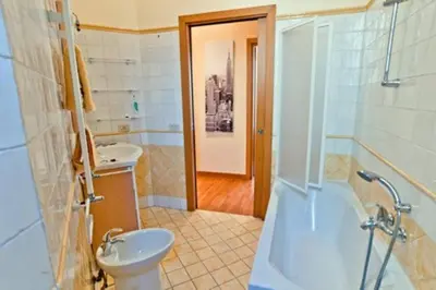 a bathroom with a toilet and a sink and a tub at Lugiadra in Rome