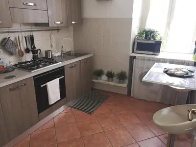 a small kitchen with a stove and a sink at Chic 'N Charme Trastevere Terrace in Rome