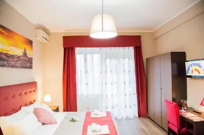 a bedroom with a bed and a large window at Vatican Suite 383 in Rome