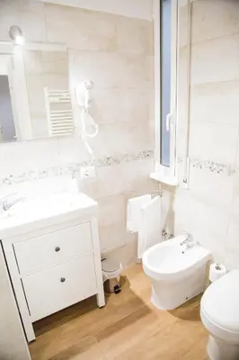 a bathroom with a sink and a toilet and a mirror at Vatican Suite 383 in Rome