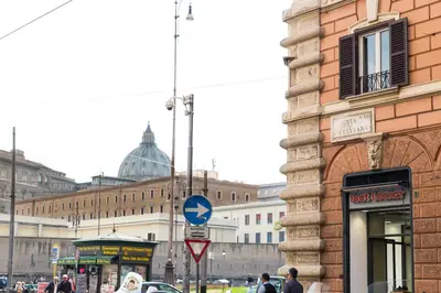 a city street with a building and a blue sign at Casa Tranquilli in Rome