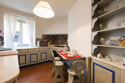 a kitchen with a table and some chairs in it at Casa Tranquilli in Rome