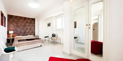 a bedroom with a bed and a tv in it at Trastevere Station Terrace in Rome