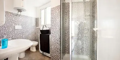 a bathroom with a shower and a sink and a toilet at Trastevere Station Terrace in Rome