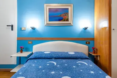 a blue bedroom with a bed with a blue wall at Alessandro A San Pietro Best Bed in Rome