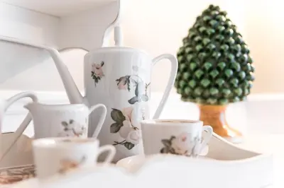 a group of tea cups and a christmas tree at Pantheon Luxury House in Rome