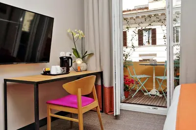 a room with a table and a chair and a window at Relais Vittoria Colonna in Rome