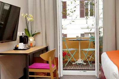 a bedroom with a door leading to a balcony with a table at Relais Vittoria Colonna in Rome