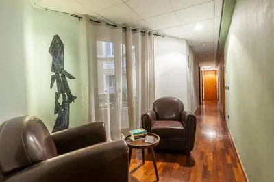 a hallway with two chairs and a table in a room at Inn Rome Rooms & Suites in Rome